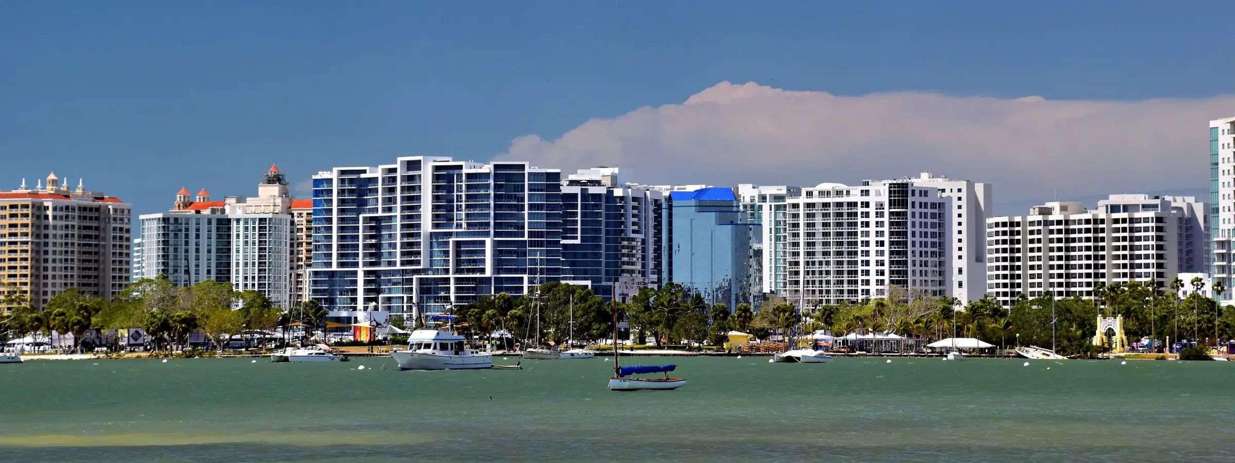 Downtown Sarasota skyline across Sarasota Bay, with boats moored in front